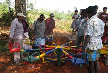 villagers inspecting playground equipment